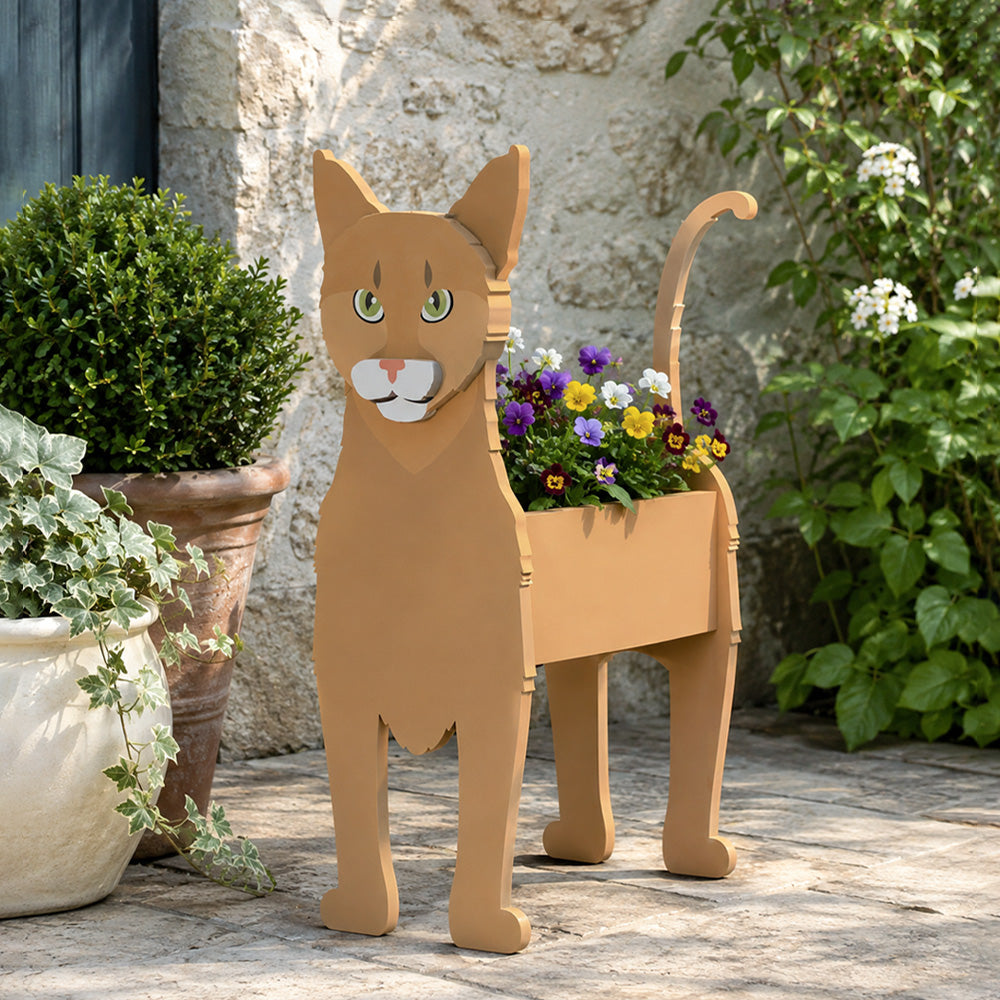 Abyssinian cat planter filled with fresh flowers is placed in the garden