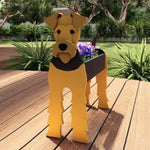 Airedale Terrier dog planter filled with fresh flowers is placed in the garden
