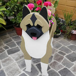 Akita Inu dog planter filled with fresh flowers is placed in the garden