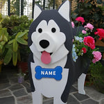 Alaska malamute shaped dog planter with a nameplate in front of garden