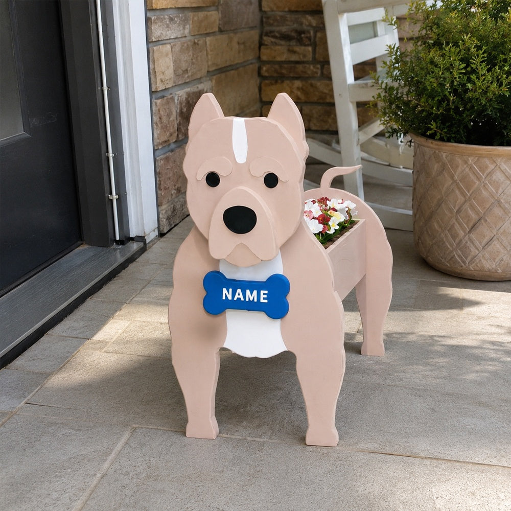 American Staffordshire Terrier dog planter filled with fresh flowers is placed in the garden