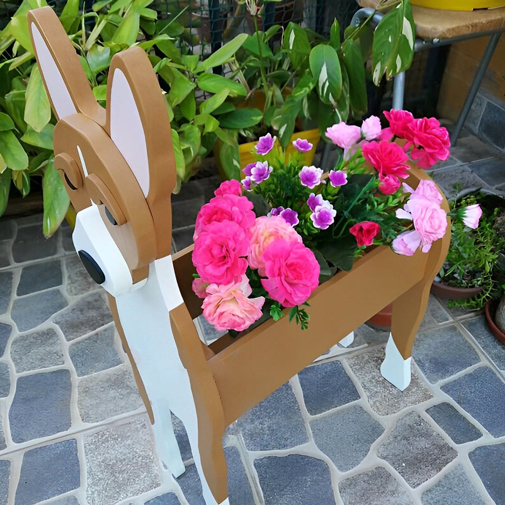 Basenji-shaped  dog planter with flowers on a stone patio