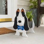 Basset Hound-shaped  dog planter with a 'NAME' tag on a porch