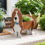 Basset Hound dog planter displayed on a patio with plants in the background