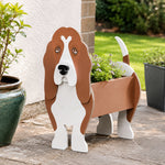 Basset Hound dog planter displayed on a patio with plants in the background
