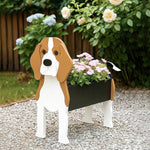 Beagle dog planter filled with fresh flowers is placed in the garden