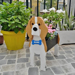 Beagle dog planter filled with fresh flowers is placed in the garden