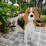 Beagle dog planter filled with fresh flowers is placed in the garden