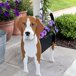 Beagle dog planter filled with fresh flowers is placed in the garden