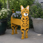Bengal cat planter filled with fresh flowers is placed in the garden