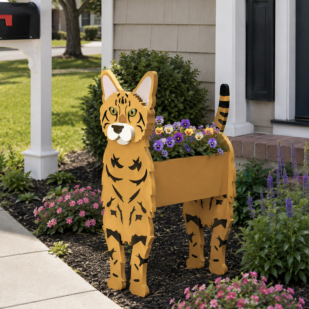 Bengal cat planter filled with fresh flowers is placed in the garden