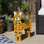 Bengal cat planter filled with fresh flowers is placed in the garden