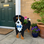 Bernese Mountain dog planter filled with fresh flowers is placed in the garden