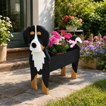 Bernese Mountain dog planter filled with fresh flowers is placed in the garden