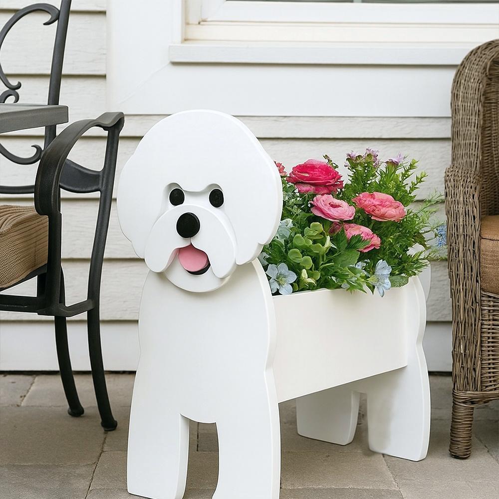 Bichon Friese dog planter filled with fresh flowers is placed in the garden