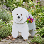 Bichon Friese dog planter filled with fresh flowers is placed in the garden