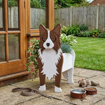 Border Collie dog planter filled with fresh flowers is placed in the garden