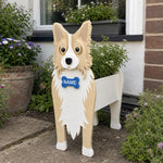 Border Collie dog planter filled with fresh flowers is placed in the garden