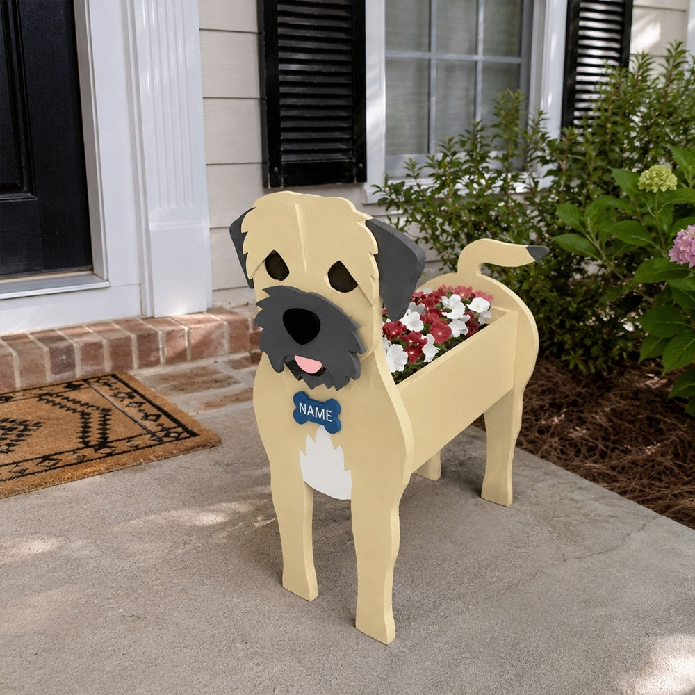 Border Terrier dog planter filled with fresh flowers is placed in the garden