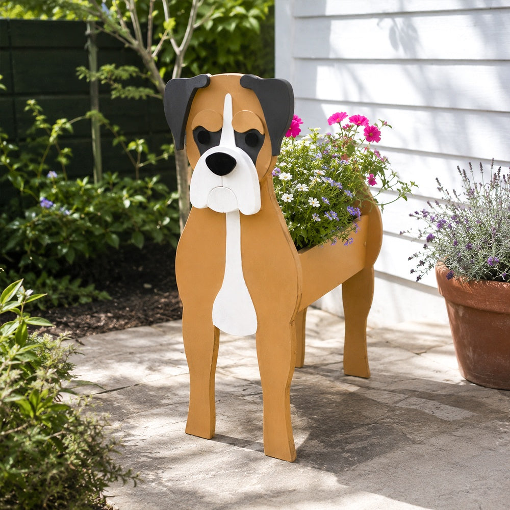 Boxer dog planter filled with fresh flowers is placed in the garden