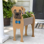Boxer dog planter filled with fresh flowers is placed in the garden