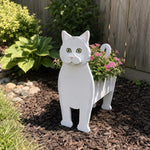 British shorthair cat planter filled with fresh flowers is placed in the garden