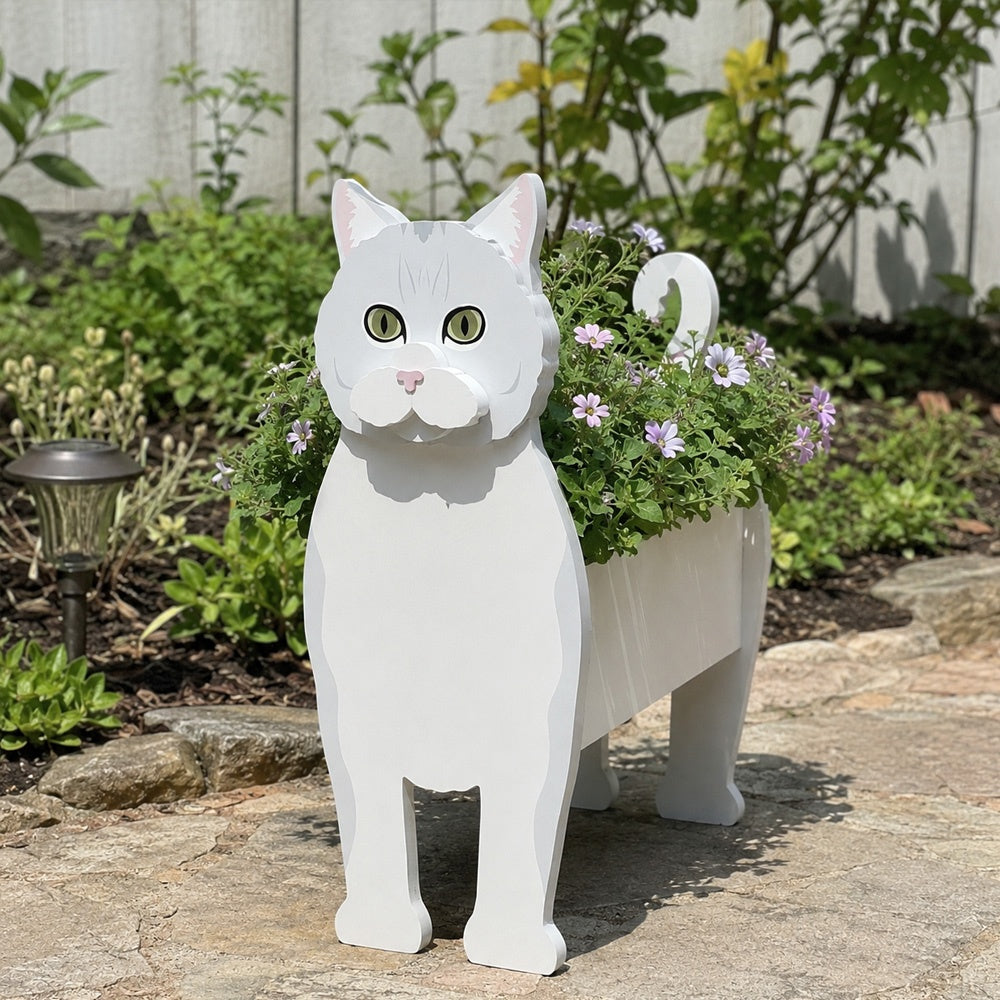 British shorthair cat planter filled with fresh flowers is placed in the garden