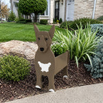 Bull Terrier dog planter filled with fresh flowers is placed in the garden