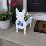Bull Terrier dog planter filled with fresh flowers is placed in the garden