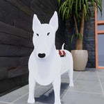Bull Terrier dog planter filled with fresh flowers is placed in the garden