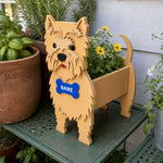 Cairn Terrier dog planter filled with fresh flowers is placed in the garden