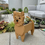 Cairn Terrier dog planter filled with fresh flowers is placed in the garden