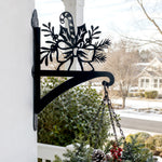 Candy cane and holly metal hanging basket bracket mounted on outdoor wall for plant decoration