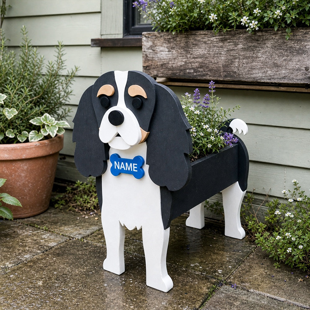 Cavalier King Charles Spaniel dog planter filled with fresh flowers is placed in the garden.
