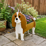 Cavalier King Charles Spaniel dog planter filled with fresh flowers is placed in the garden.