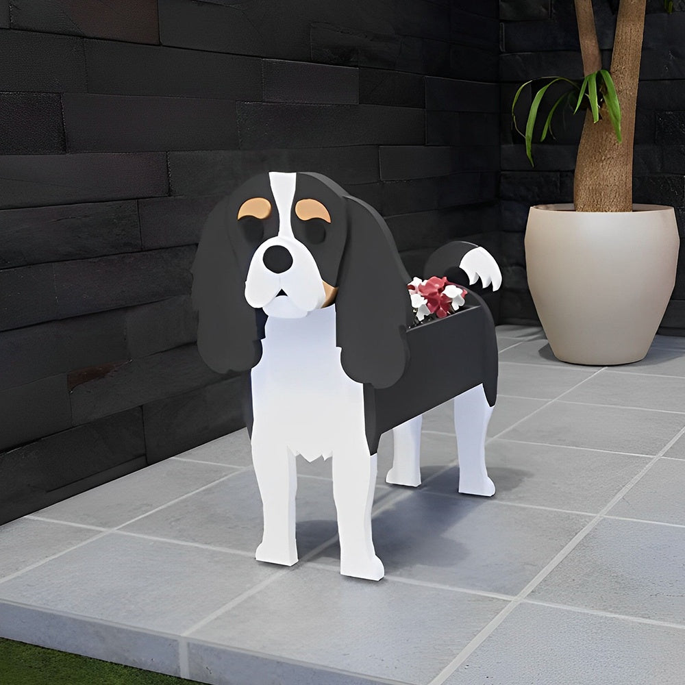 Cavalier King Charles Spaniel dog planter filled with fresh flowers is placed in the garden.
