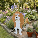 Cavalier King Charles Spaniel dog planter filled with fresh flowers is placed in the garden.