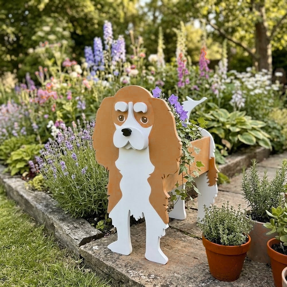 Cavalier King Charles Spaniel dog planter filled with fresh flowers is placed in the garden.