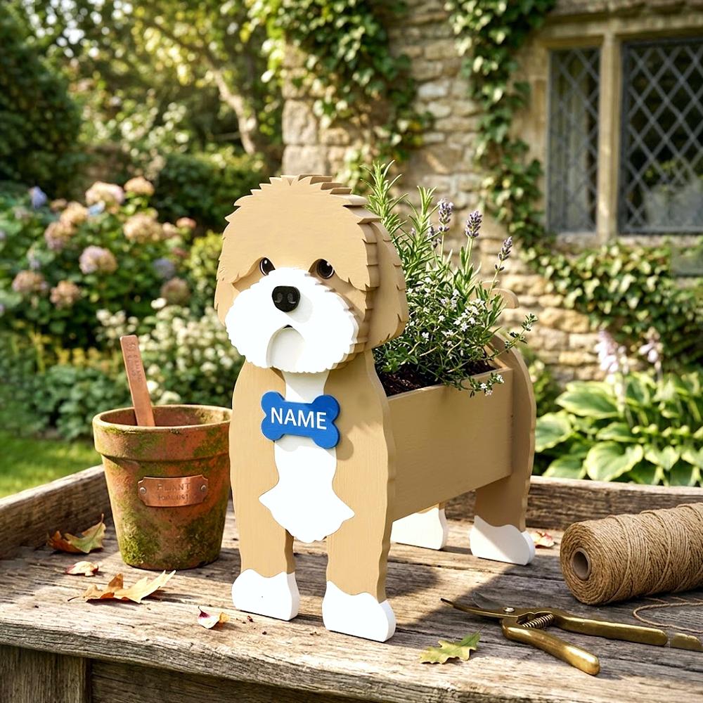 Cavapoo-shaped dog planter with a name tag on a wooden table in a garden setting