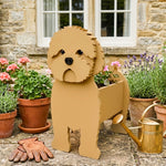 Brown cavapoo-shaped dog planter containing flowers, placed beneath a windowsill