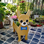 Chihuahua dog planter filled with fresh flowers is placed in the garden
