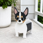 Chihuahua dog planter filled with fresh flowers is placed in the garden