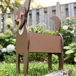 Chihuahua dog planter filled with fresh flowers is placed in the garden