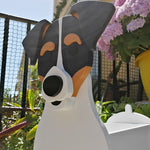 Chilean Fox Terrier dog planter filled with fresh flowers is placed in the garden