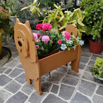 Chow Chow dog planter filled with fresh flowers is placed in the garden