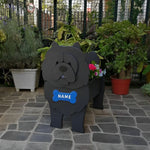 Chow Chow dog planter filled with fresh flowers is placed in the garden