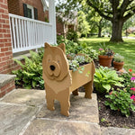 Chow Chow dog planter filled with fresh flowers is placed in the garden