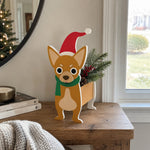 Christmas Chihuahua dog planter filled with fresh flowers is placed in the garden