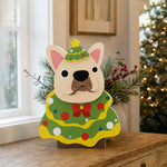 Christmas French Bulldog planter filled with fresh flowers is placed in the garden
