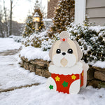 Christmas Lhasa Apso dog planter filled with fresh flowers is placed in the garden